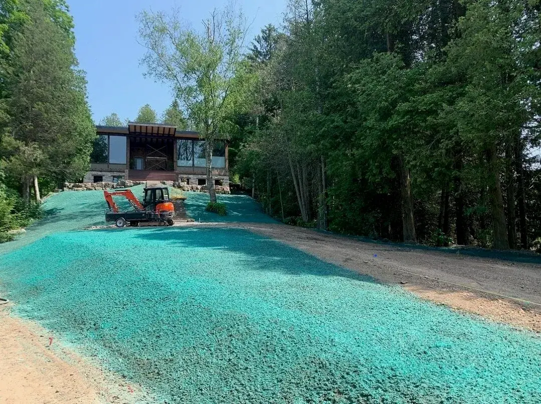Hydroseeded residential slope with compact excavator on-site