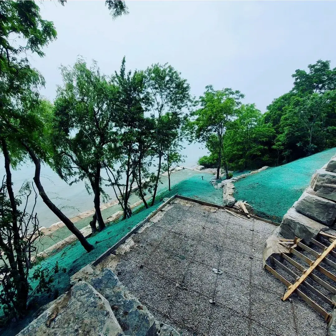 Lakeside property with hydroseeded slopes and stone steps